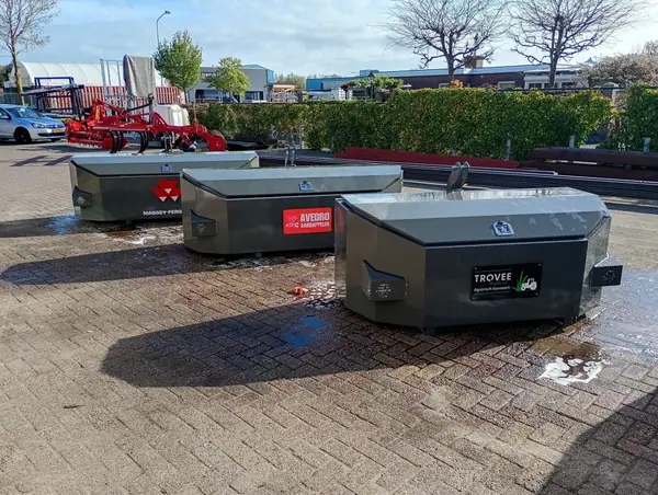 Drie grijze frontgewichten met Massey Ferguson-logo en eigen bedrijfsnamen